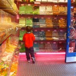 Photo: Small child looking at a wall of candy in a candy store