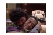 Screenshot of a Cosby Show episode featuring Cliff and Claire snuggling on the sofa